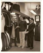 young man looking at suit jackets at Cable Car Clothiers in the 1950s